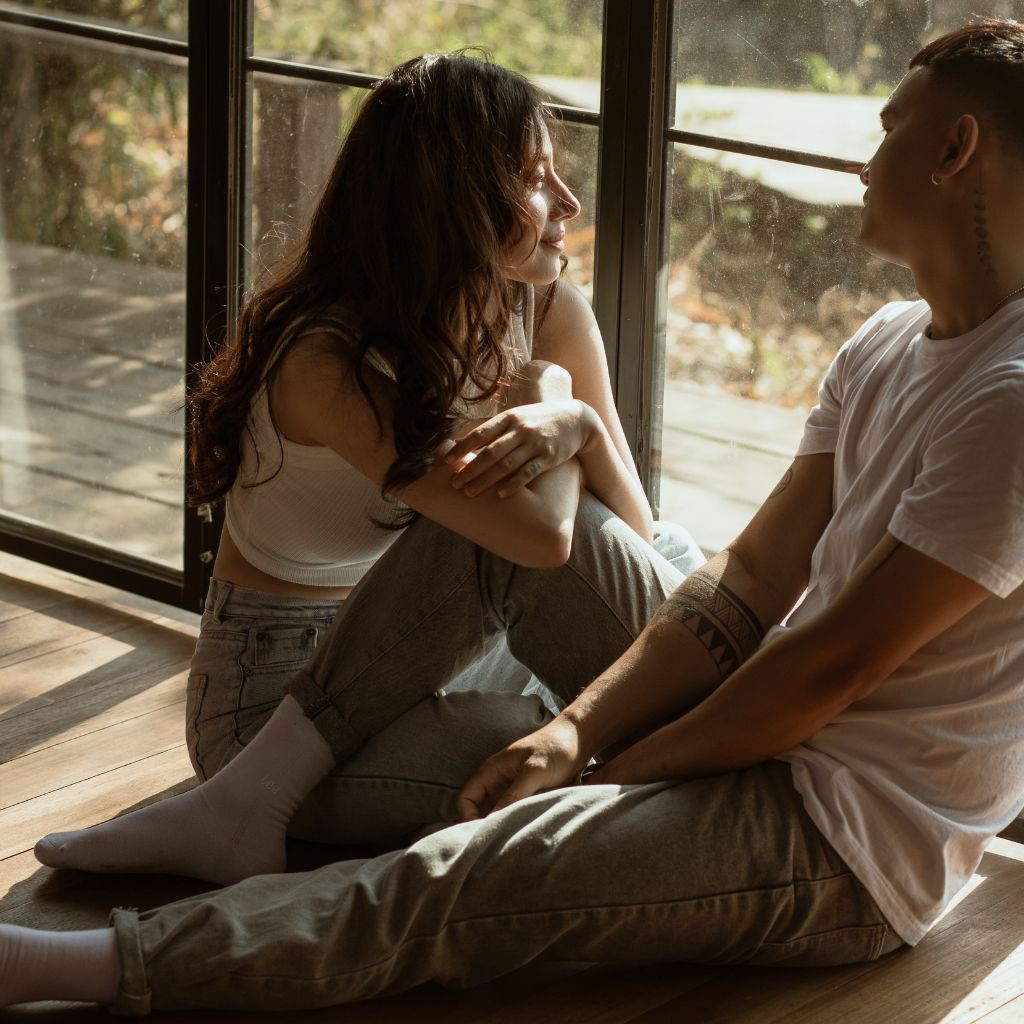 Romantic couple sitting together by a window