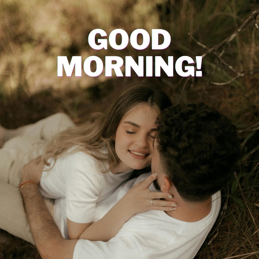 Couple lying together outdoors in a gentle embrace, with “GOOD MORNING!” written in large white text above them.